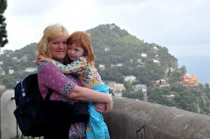 A mother and child with a view of Capri behind